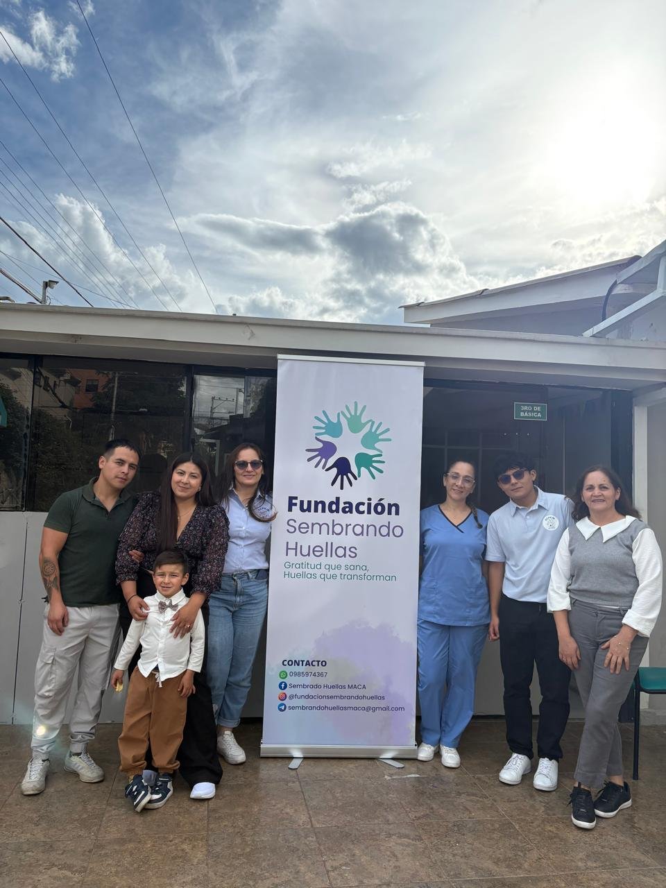 Familia junto al banner de la fundación en una jornada